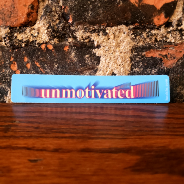 "unmotivated" sticker in gray with an extended shadow behind it that shifts from magenta to black. It's reminiscent of Windows 95 clipart software.